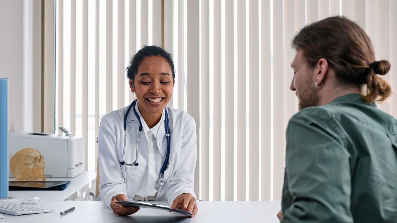 A doctor and patient talking in a bright clinic