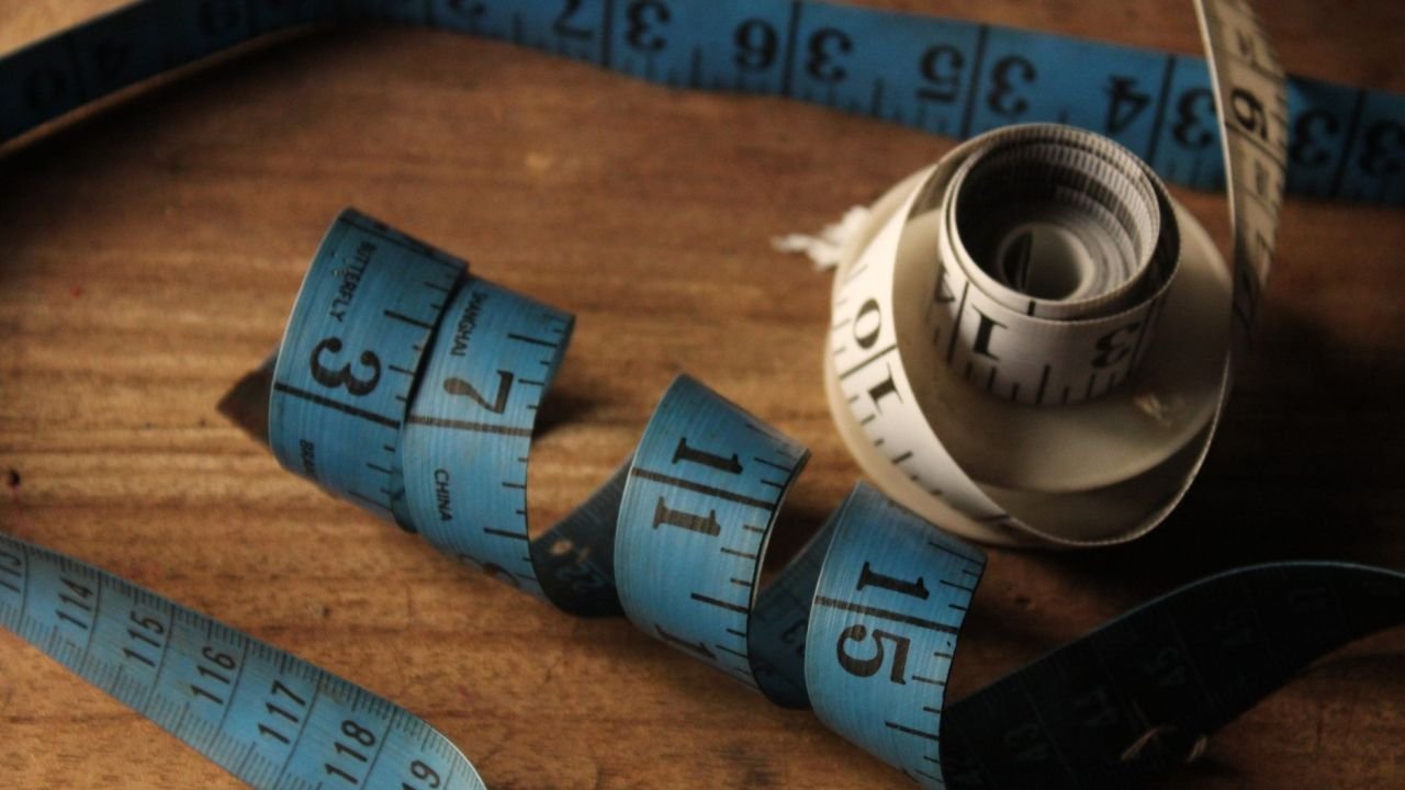 Rolled measuring tapes on a wooden surface