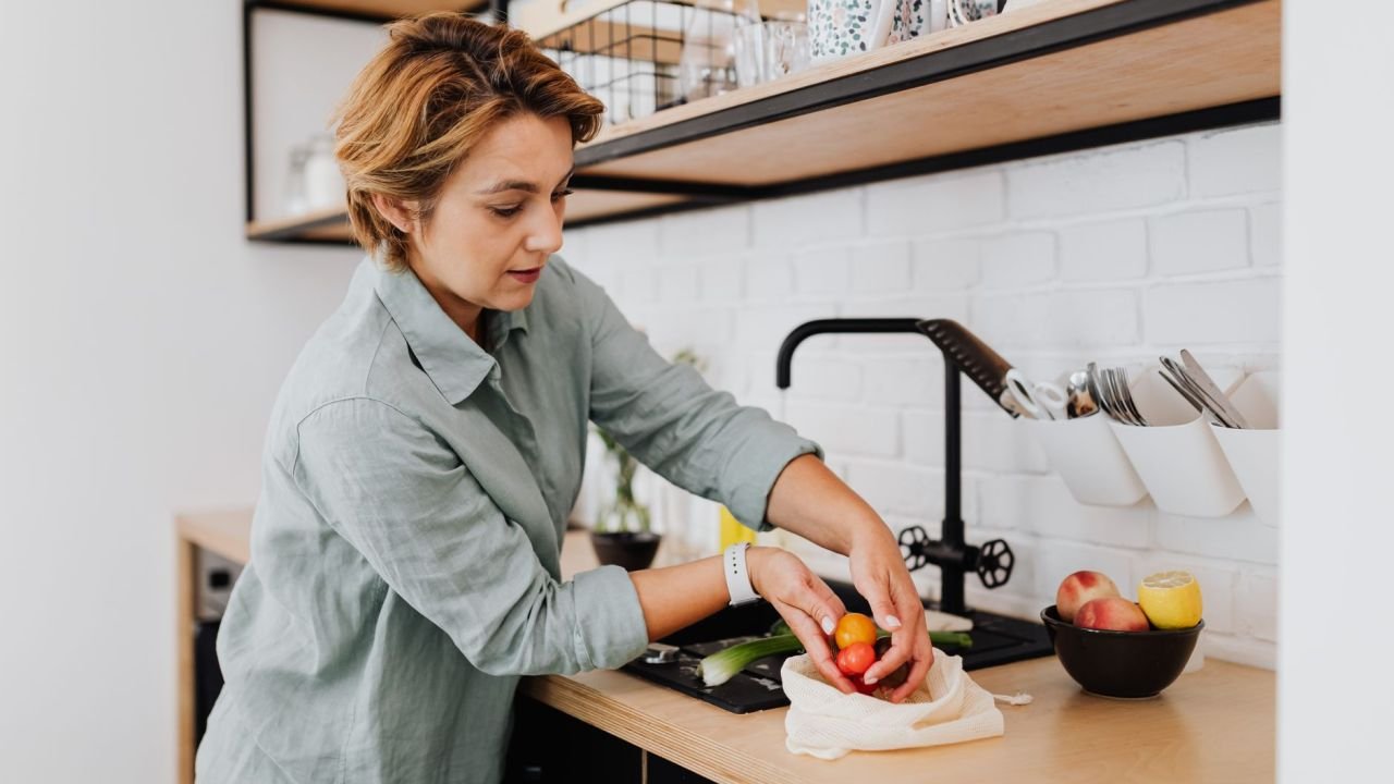 A woman preparing fresh vegetables in a kitchen