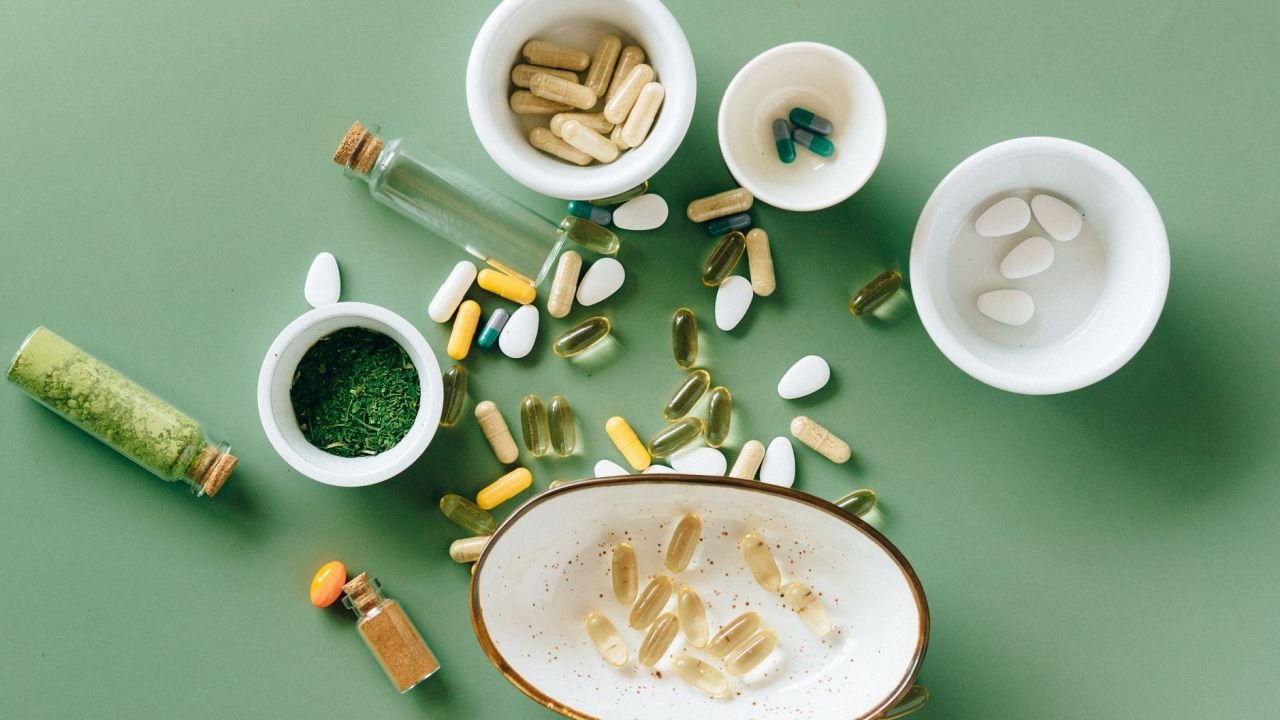 Herbal and pharmaceutical supplements in bowls, seen from above
