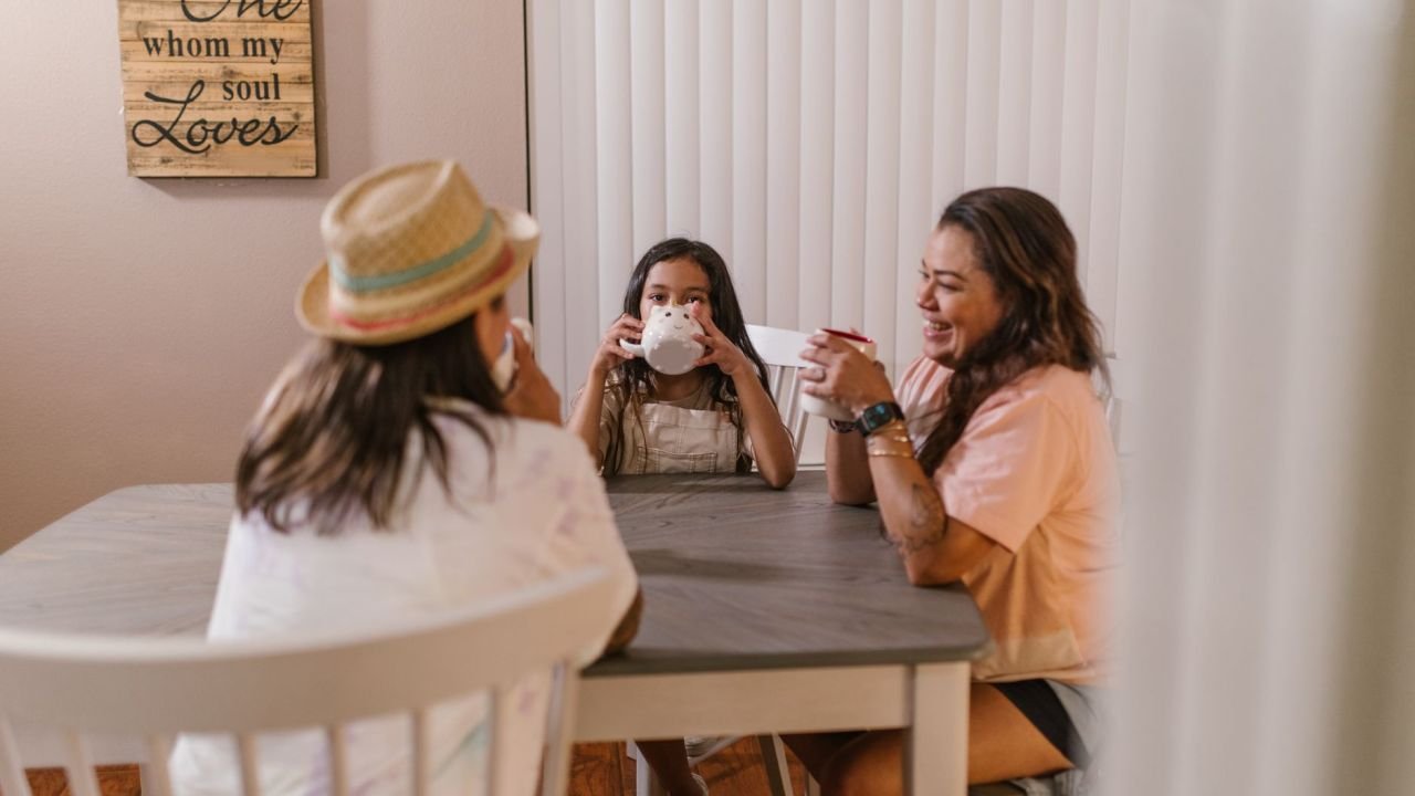 A family sitting around a table together over tea